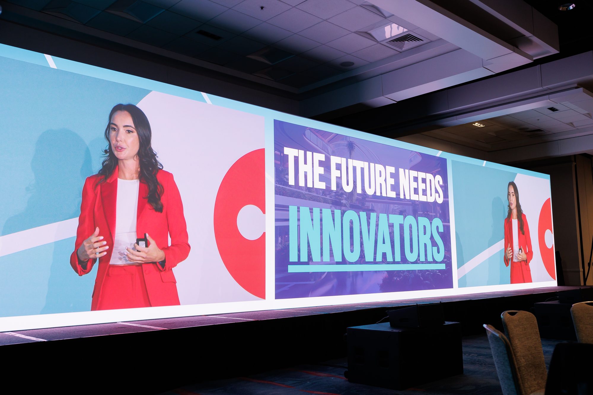 Sam Rad on stage at CITE beside a screen reading The Future Needs Innovators